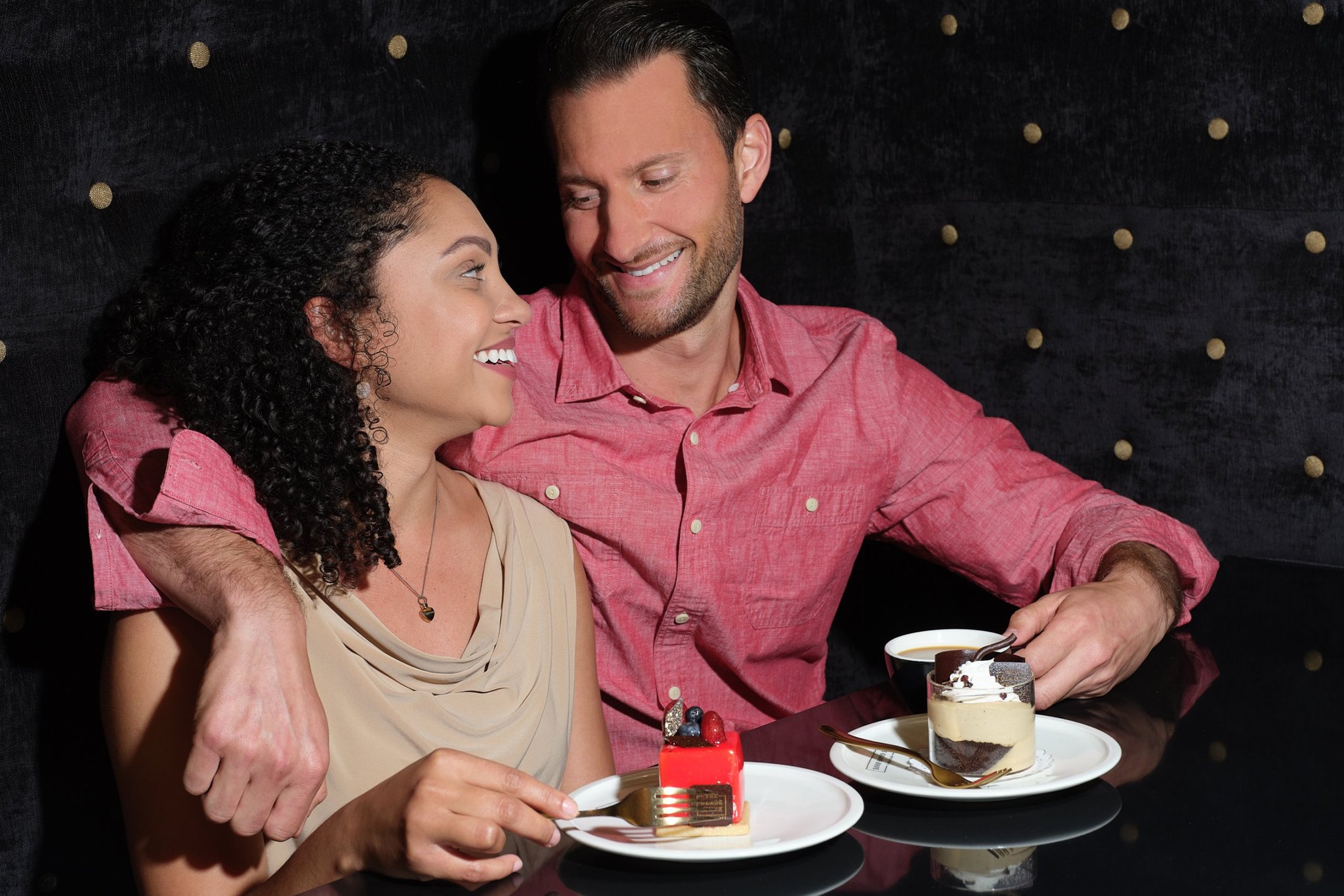 A couple enjoying dessert during a romantic date night at The Glass knife.