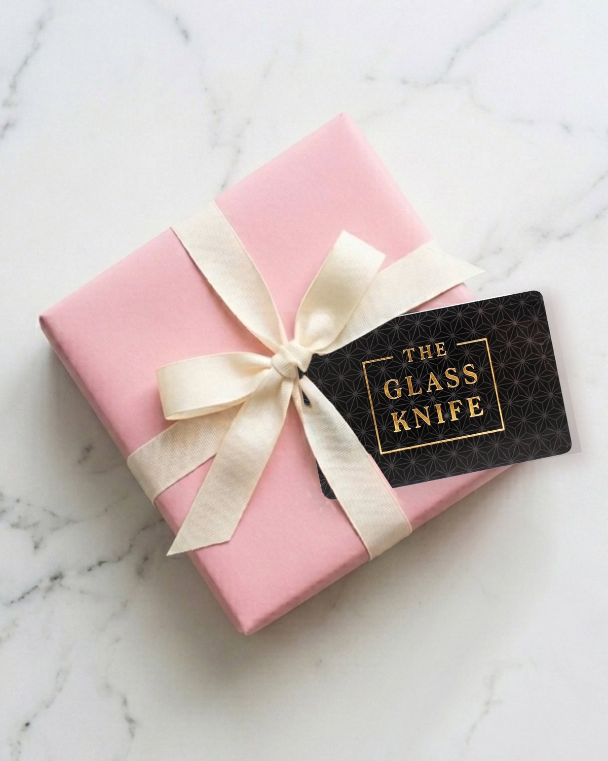 The Glass Knife gift card with pink gift box.