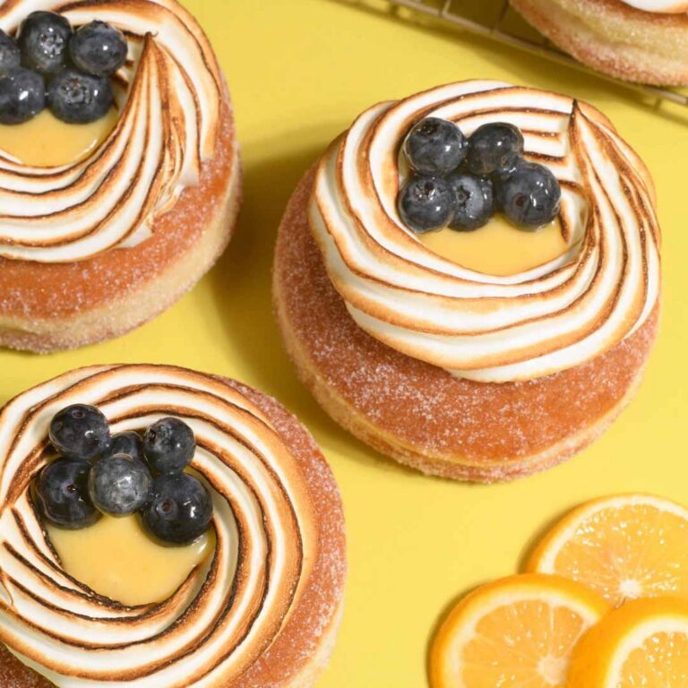 Lemon meringue donut with toasted meringue and citrus glaze