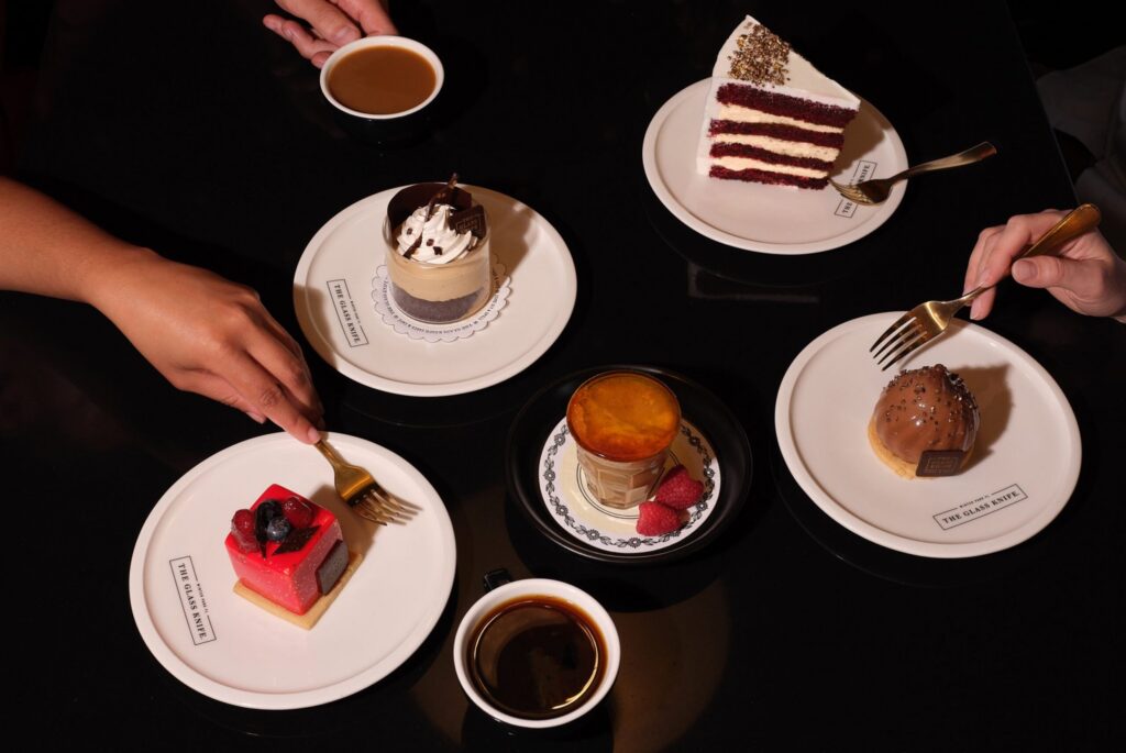 Assortment of layer cakes, pastries and coffee shared among friends